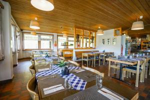 a restaurant with tables and chairs in a room at Berggasthaus Tannalp in Frutt