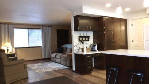 a kitchen and living room with a couch and a table at Fern Hill Retreat in Chehalis