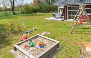 a sandbox with toys in the sand in a yard at Cozy Home In Krems Ii-warderbrck With Sauna in Göls