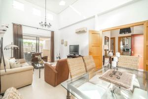 ein Wohnzimmer mit Sofa und Tisch in der Unterkunft Villa con Piscina Privada de La Torre Golf Resort Murcia - CA13LT in Torre-Pacheco