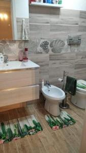 a bathroom with a sink and a toilet at Appartamento al Mare Solanas in Solanas
