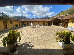 a courtyard with potted plants and a building at Barão do Vale in Itaipava +17 photos