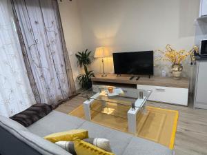 a living room with a couch and a tv at Beautiful View 1 - Arco da Calheta - Ilha da Madeira in Arco da Calheta
