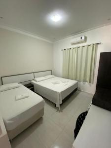 מיטה או מיטות בחדר ב-Prime Hotel Hortolândia