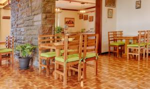 a dining room with a wooden table and chairs at Casa Carrión in Quito