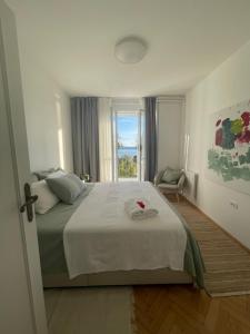 a bedroom with a large bed and a window at Apartment Solare in Portorož