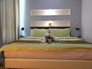 a bedroom with a large bed with flowers on it at Shaftsbury Residence Cyberjaya Wifi, Netflix, Free Parking in Cyberjaya