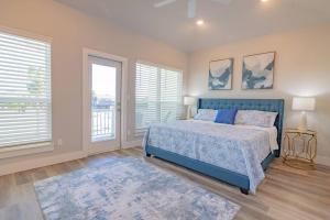 a bedroom with a blue bed and two windows at Private Pool Magnolia's Coastal Escape in Corpus Christi +23 photos