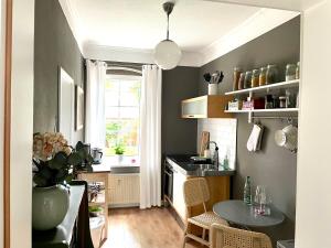a kitchen with a table and a small kitchen with a window at JETHON Appartement in der Gasse in Nienburg
