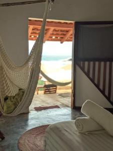 a hammock in a room with a view of the ocean at Casa Corazón San Agustinillo in San Agustinillo