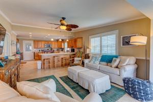a living room with a couch and a kitchen at Bathing Suit Beach Bungalow in Ormond Beach