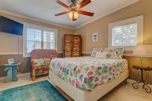 a bedroom with a bed and a ceiling fan at Bathing Suit Beach Bungalow in Ormond Beach