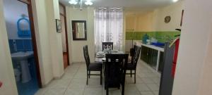 a dining room with a table and chairs in a kitchen at CHILL OUT in Huanchaco