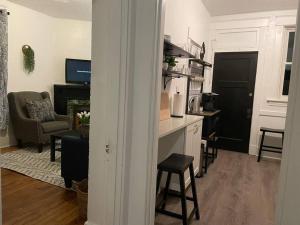 a room with a kitchen and a living room at Lovely 2BR w Office space - KING BED & ALEXA in Pittsburgh