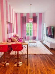 a living room with pink and purple stripes at Dolly's Delight - Boutique Bliss Mins From Broadway in Nashville