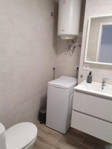 a white bathroom with a toilet and a sink at Estudio Céntrico in Puerto de la Cruz