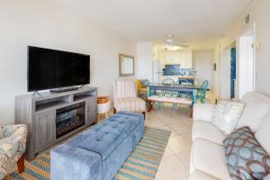 a living room with a couch and a flat screen tv at Plantation East IV in Gulf Shores