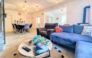een woonkamer met een blauwe bank en een tafel bij Nice Home In Vrgorac With Wifi in Vrgorac
