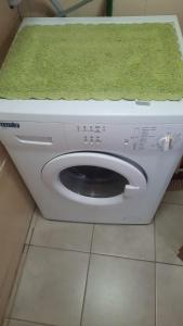 a washing machine with a green towel on top of it at Cabaña del Antiguo Poblador in Ushuaia