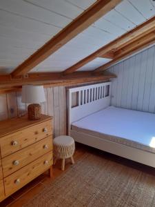 a attic bedroom with two beds and a dresser at Hygge chaloupka v horách in Český Jiřetín