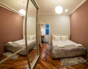Dos camas en una habitación con espejo. en MOLDOs Haus, en Sibiu