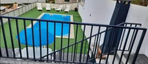 a balcony with a view of a swimming pool at Alojamento Silva in Castelo de Paiva