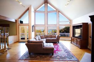 a living room with a couch and a large window at Hill View Motel and Cottages in Lake George