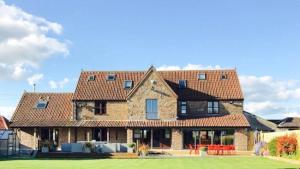 a large brick house with red roof at Drystone Manor - Swim Hot Tub, Tennis, Gatherings in Iron Acton