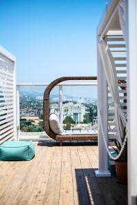 a balcony with a hammock and a view of a city at Andaz West Hollywood-a concept by Hyatt in Los Angeles