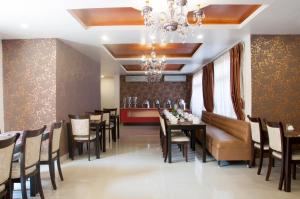 a dining room with a table and chairs and a chandelier at Mandala Boutique Hotel in Kathmandu