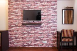 a brick wall with a tv on top of it at Mandala Boutique Hotel in Kathmandu