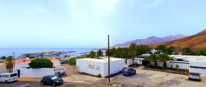 a parking lot with cars parked in front of a building at Jandia Mar 4 in Morro del Jable