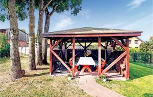 a wooden gazebo with a table in it at 2 Bedroom Stunning Home In Mielno in Mielno