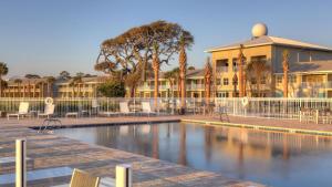 a swimming pool in front of a building at Holiday Inn Resort Jekyll Island, an IHG Hotel in Jekyll Island