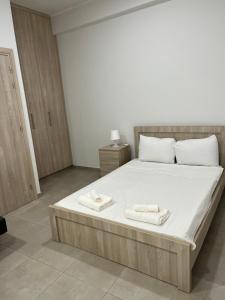 a bedroom with a large bed with two towels on it at Modern city center studio saripolou in Limassol