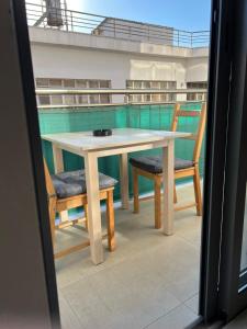 a table and chairs on the balcony of a boat at Modern city center studio saripolou in Limassol