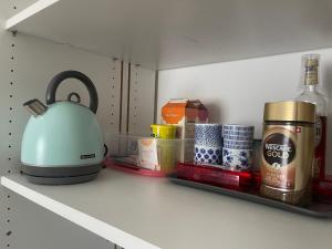 a tea kettle sitting on a shelf in a refrigerator at Happy Connection in Villarvolard