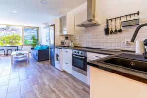 a kitchen with a sink and a stove top oven at La Cascada 202 in Puerto Rico de Gran Canaria +9 photos