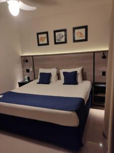 ein Schlafzimmer mit einem großen Bett mit blauen Kissen in der Unterkunft Summit Beach Hotel Boiçucanga in Boicucanga