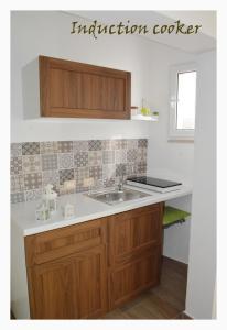 a kitchen with a sink and a counter top at B&B Nuova Salento in Grottaglie