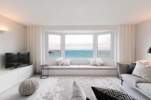a living room with a window with a view of the ocean at Golden Heights in Carbis Bay