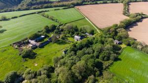 an aerial view of a farm with a field and trees at Henllys Lodge in Velindre-farchog