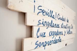 a stack of reclaimed wood pallets with handwriting on them at Apartamentos Diaber Laraña in Seville