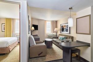 a hotel room with a bed a desk and a couch at Candlewood Suites NYC -Times Square, an IHG Hotel in New York