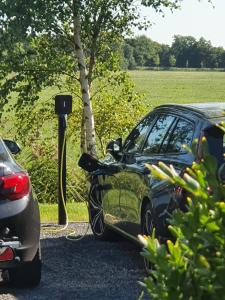 a car is hooked up to a car charger at Hippe Schuur in Tietjerk