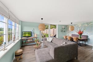 a living room with a couch and a table at Beach & Forest Retreat -Domburg- in Oostkapelle