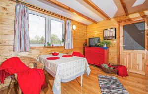 a dining room with a table and chairs and a television at Nice Home In Ustka-Przewloka With Wifi in Ustka