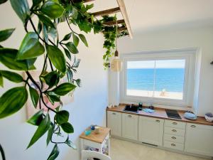 a room with a window overlooking the ocean at Seafront Holidays & Workstays in Molfetta