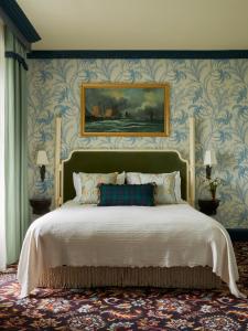 a bedroom with a large bed with blue wallpaper at Marine Troon in Troon