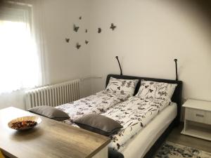 1 dormitorio con 1 cama con mariposas en la pared en Apartman * VICTORY * en Banja Luka